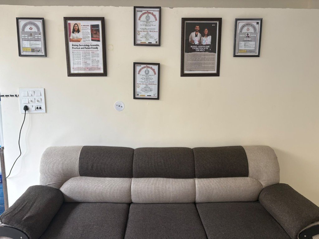 Certificates and media features on the wall at Ojas Skin Clinic
